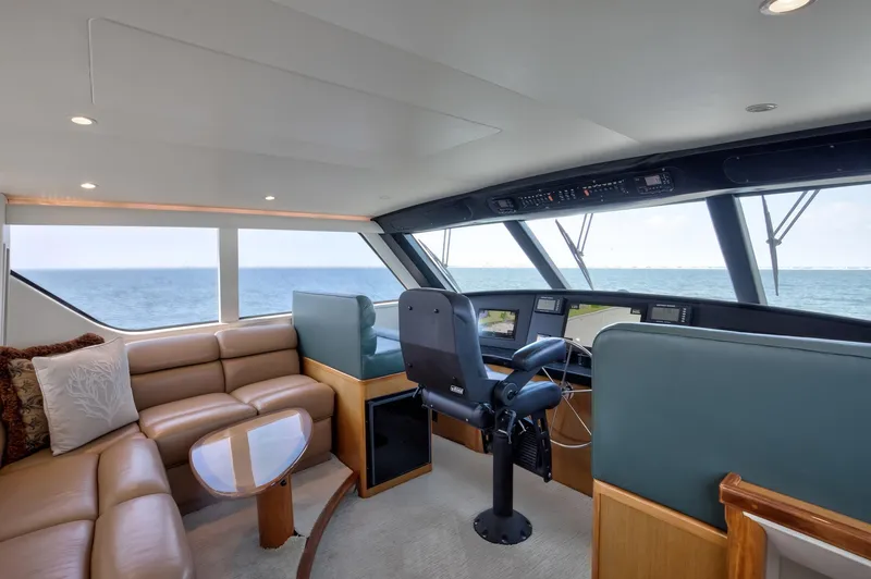 Good To Go Yacht Photos Pics Luxurious 2002 Viking 61 yacht interior with ocean view, featuring plush seating and modern helm.