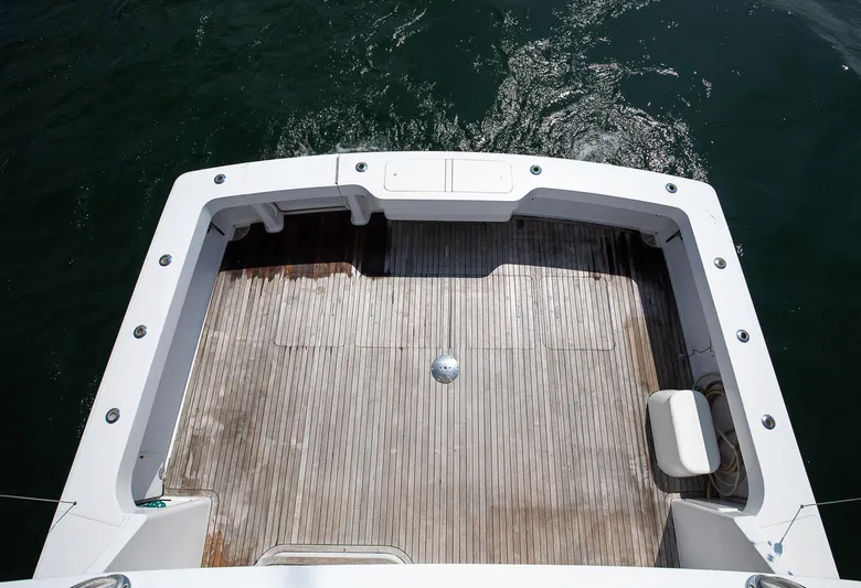 Good To Go Yacht Photos Pics 2002 Viking 61 yacht deck with wooden flooring, surrounded by water.