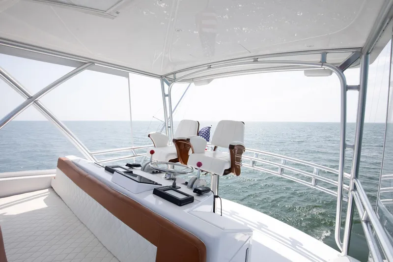 Good To Go Yacht Photos Pics Flybridge of 2002 Viking 61 yacht with ocean view, featuring helm chairs and navigation equipment.