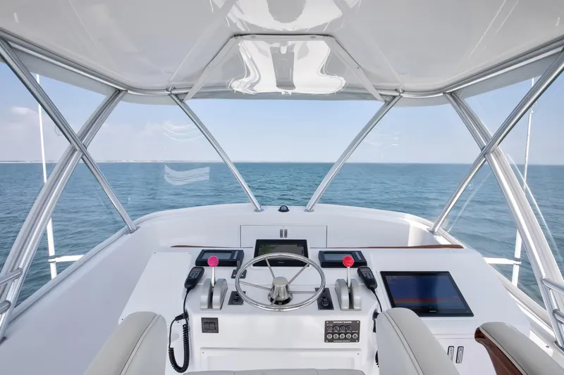 Good To Go Yacht Photos Pics Helm of 2002 Viking 61 yacht with ocean view, featuring modern controls and navigation equipment.