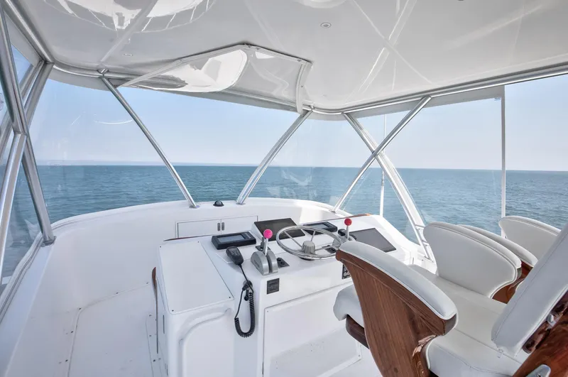 Good To Go Yacht Photos Pics Helm of 2002 Viking 61 yacht with ocean view, featuring modern controls and seating.