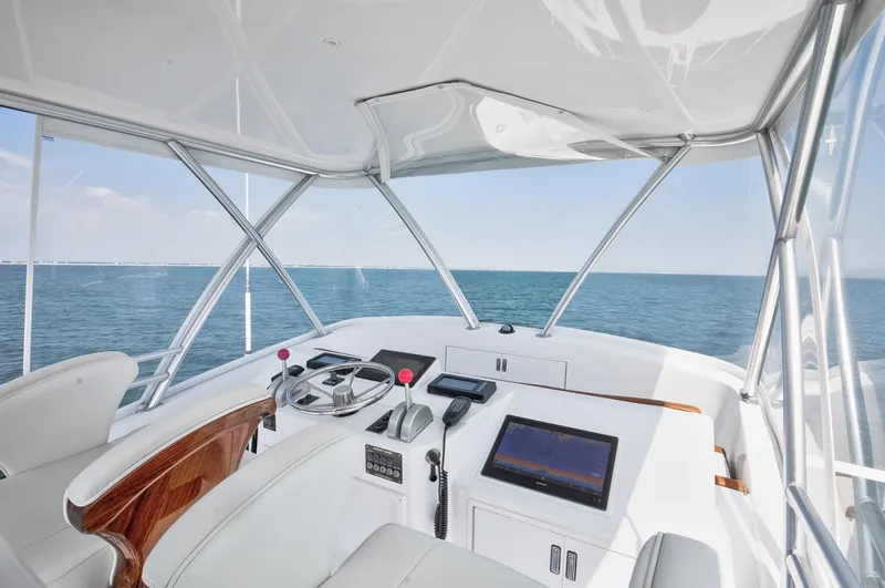 Good To Go Yacht Photos Pics Helm of 2002 Viking 61 yacht with ocean view, featuring modern navigation equipment.