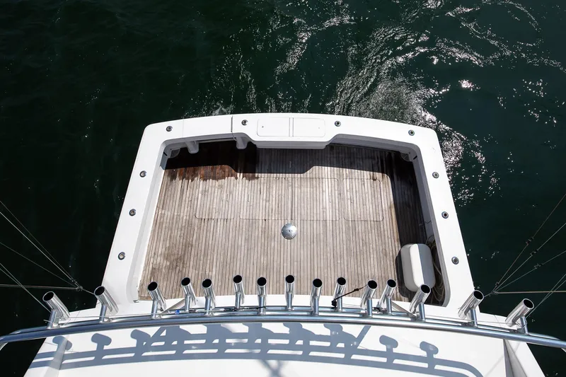 Good To Go Yacht Photos Pics Rear deck of a 2002 Viking 61 yacht with rod holders, overlooking the water.