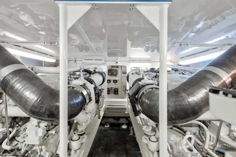Good To Go Yacht Photos Pics Engine room of a 2002 Viking 61 yacht, showcasing dual engines and control panel.