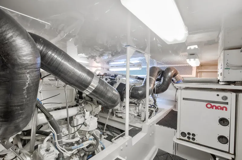 Good To Go Yacht Photos Pics Engine room of a 2002 Viking 61 yacht, featuring Onan generator and complex piping system.