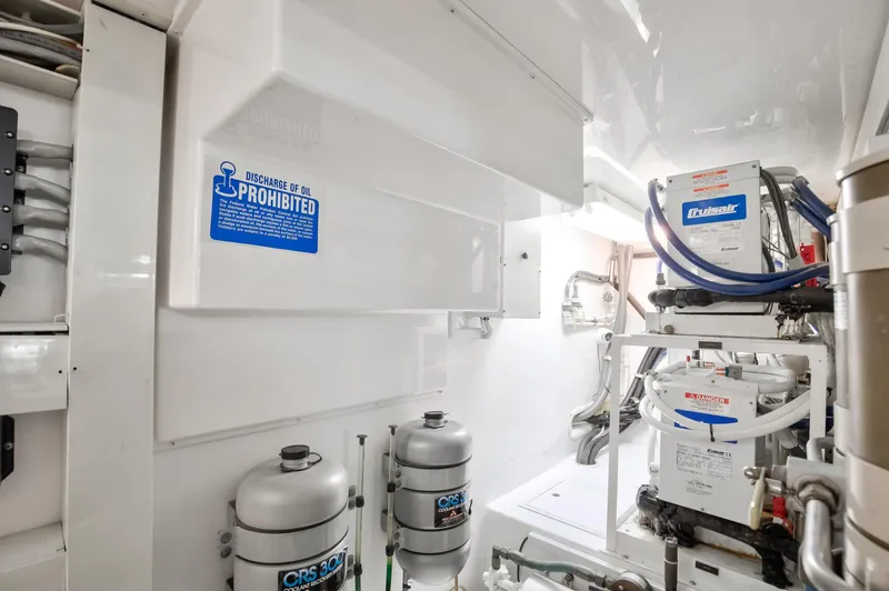 Good To Go Yacht Photos Pics Engine room of 2002 Viking 61 yacht with mechanical equipment and safety signage.