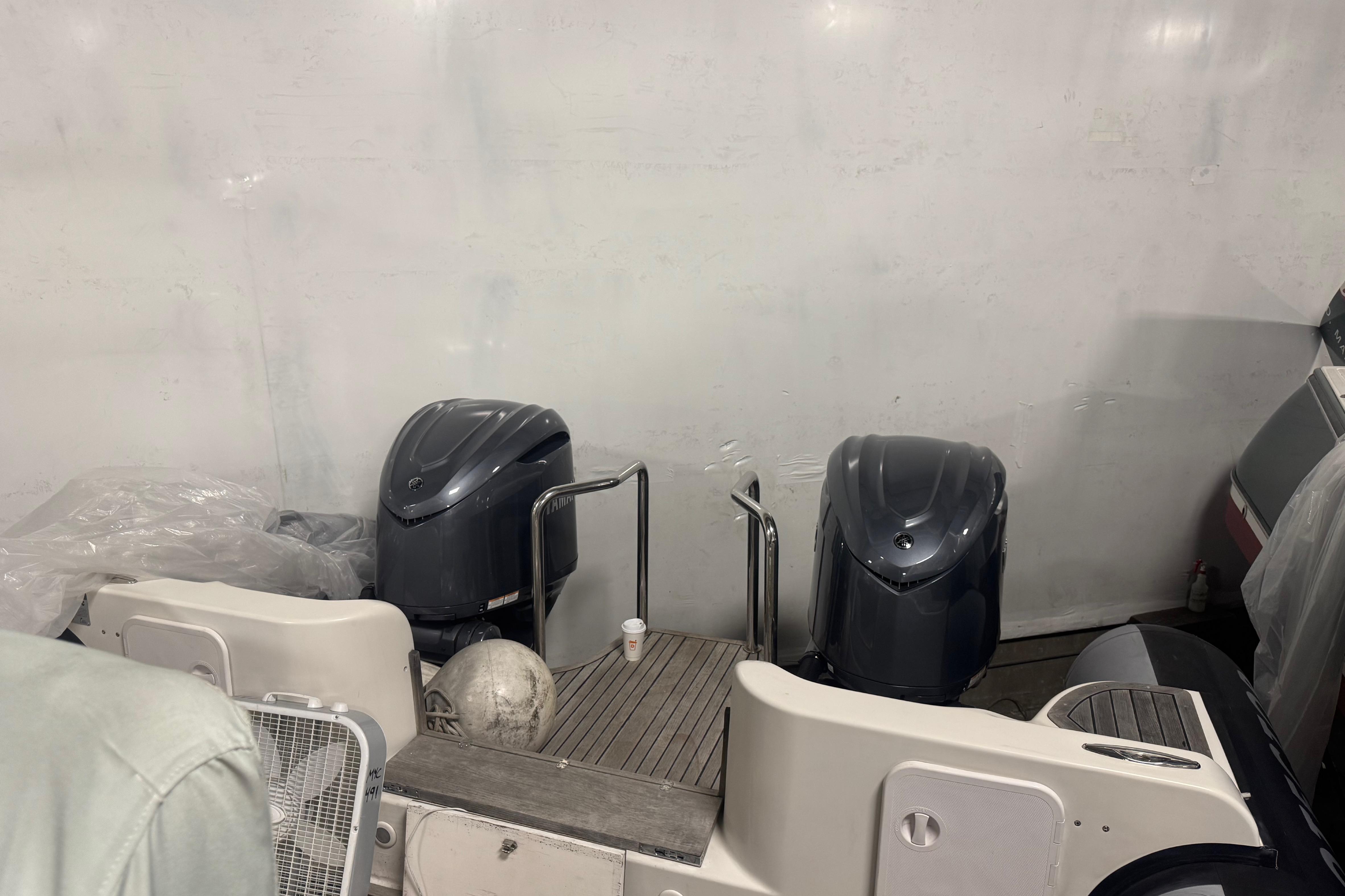 2016 Protector Tauranga 41 boat engines in a storage area.