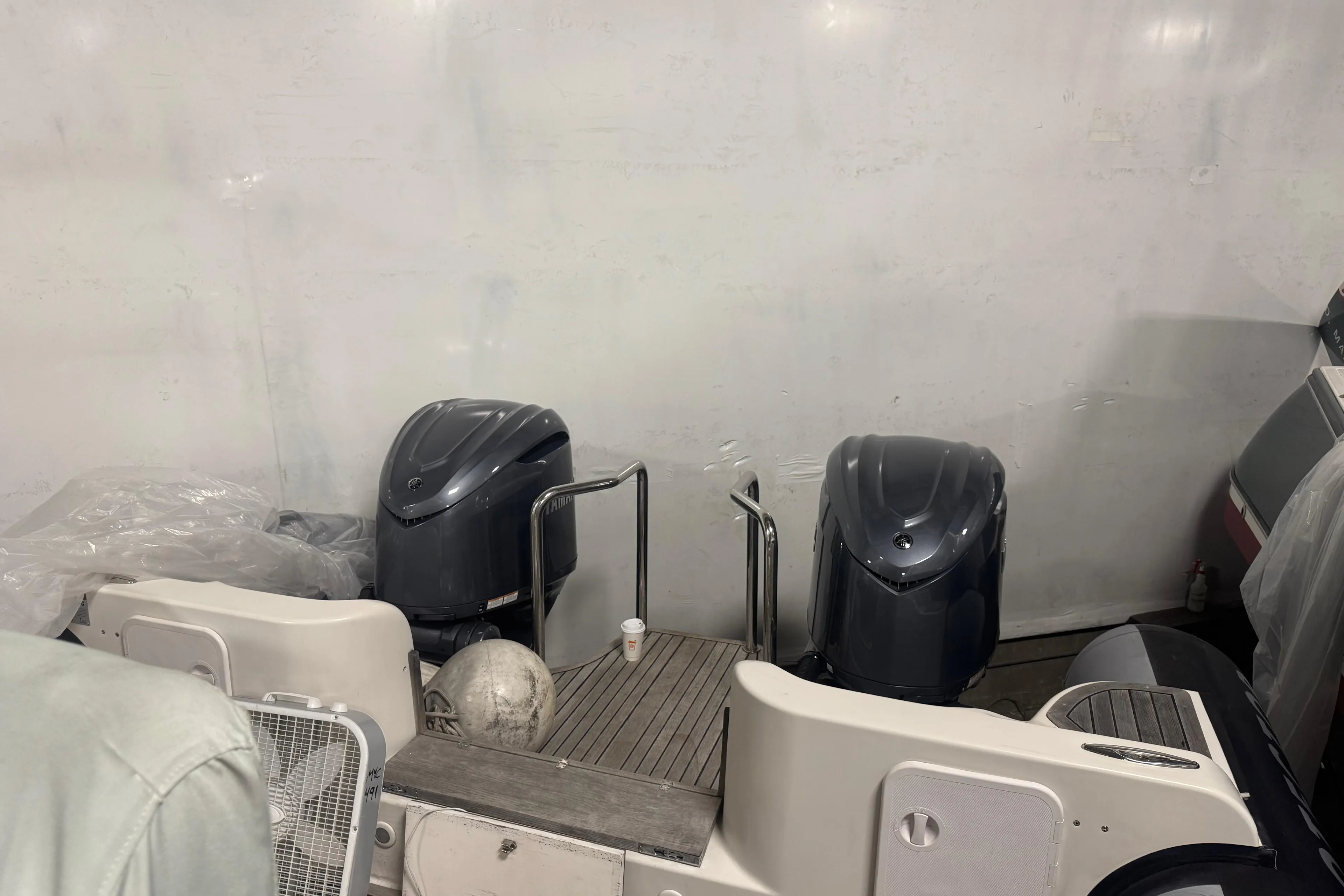 2016 Protector Tauranga 41 boat engines in a storage area.