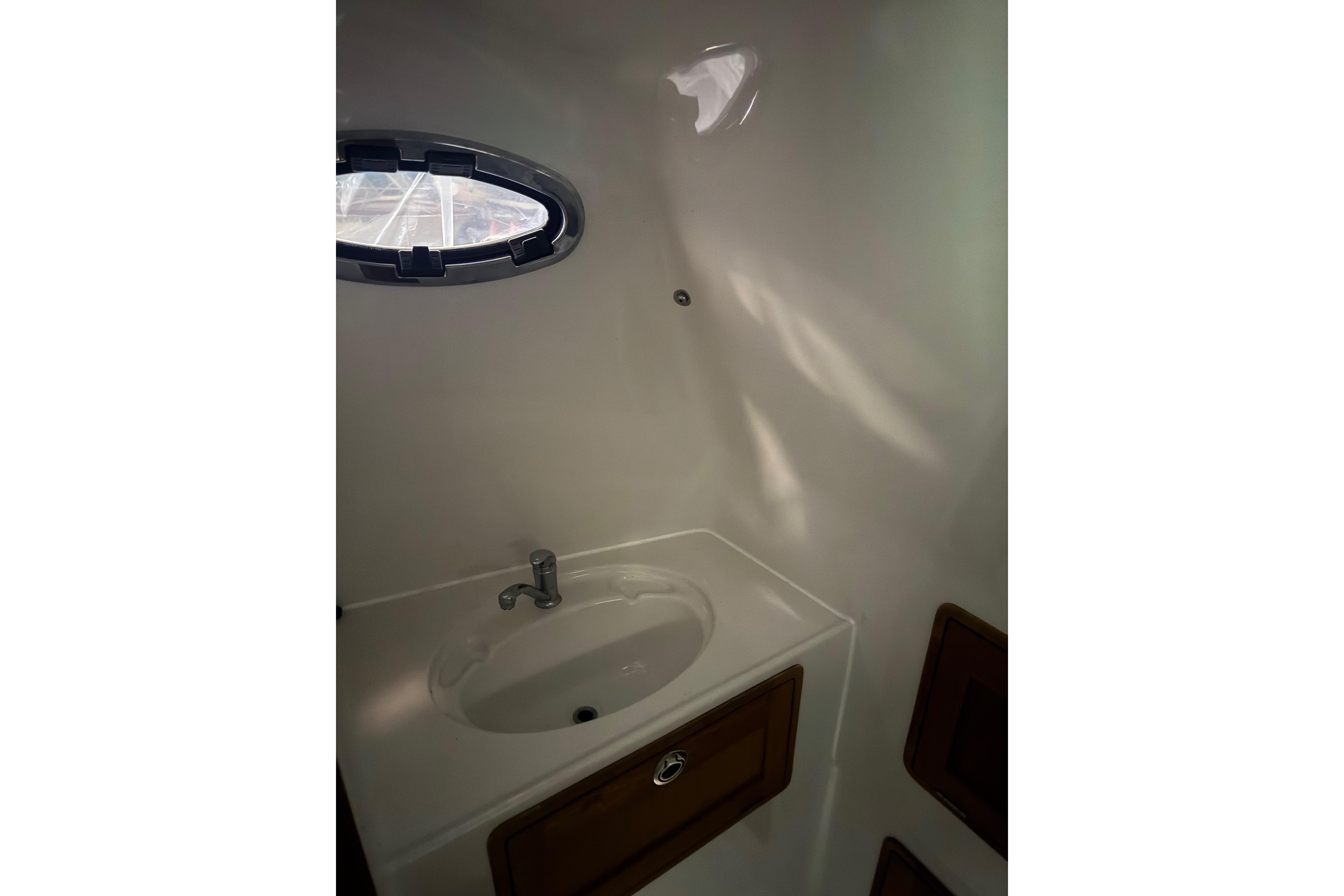 Compact bathroom sink in 2016 Protector Tauranga 41 boat interior.