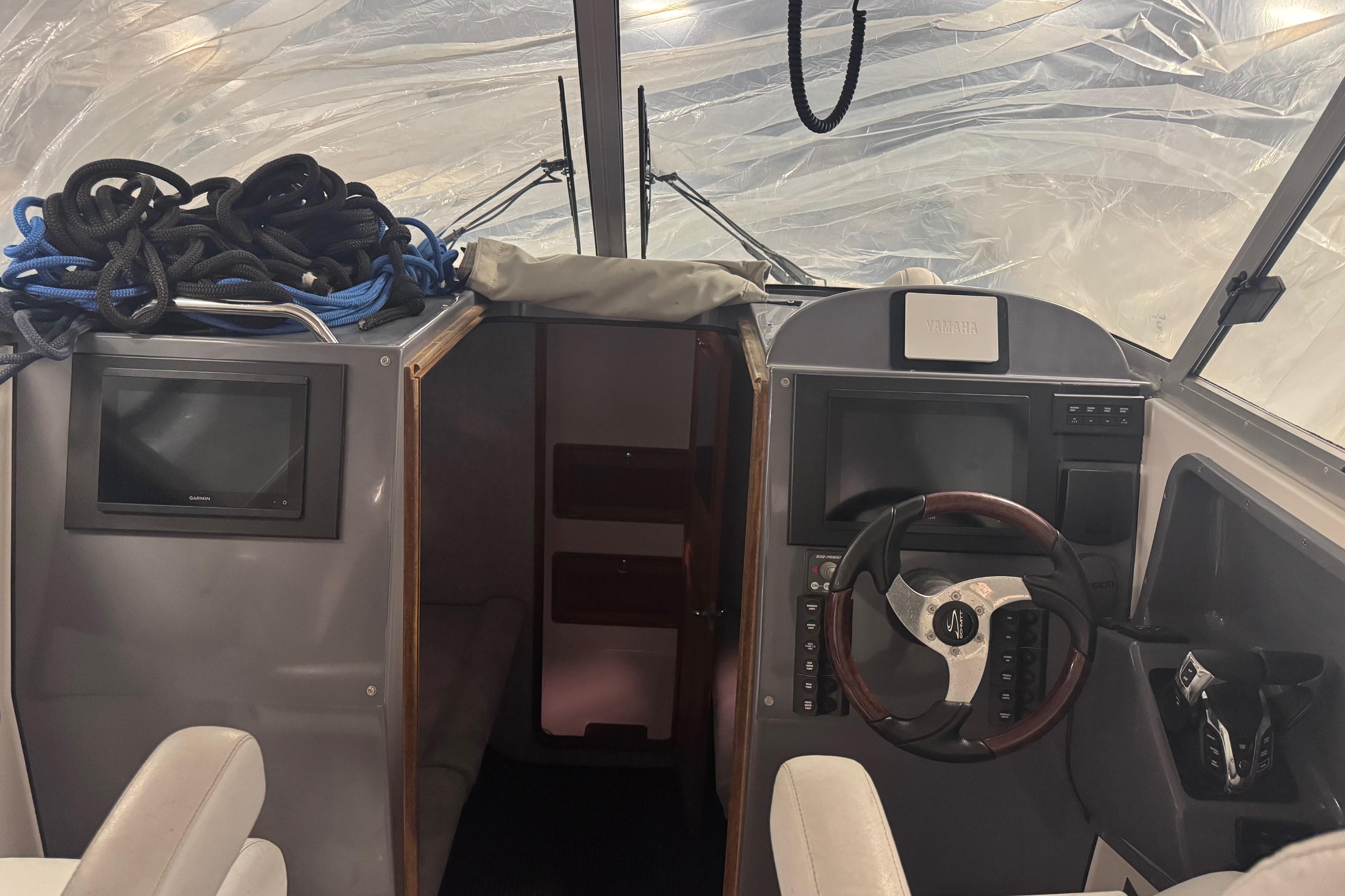 Interior of 2016 Protector Tauranga 41 boat with steering wheel and navigation equipment.