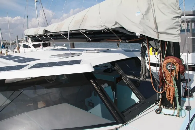 Starship Yacht Photos Pics Gunboat 55 catamaran, 2017 model, featuring solar panels and rigging, docked at a marina.