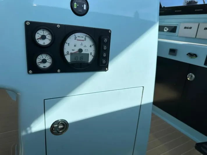 Starship Yacht Photos Pics Control panel of a 2017 Gunboat 55 yacht, featuring gauges and a lockable compartment.