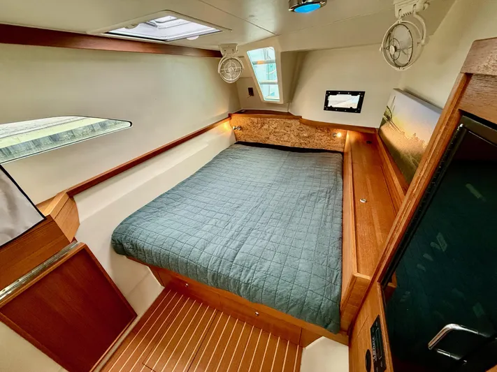 Starship Yacht Photos Pics Luxurious cabin interior of 2017 Gunboat 55 with cozy bed and wooden accents.