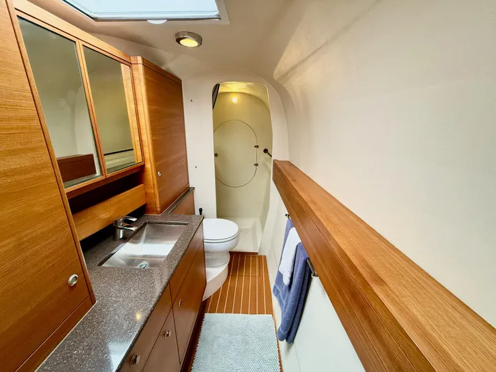 Starship Yacht Photos Pics Luxurious bathroom in 2017 Gunboat 55 yacht with wood accents and modern fixtures.