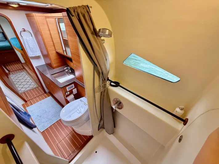 Starship Yacht Photos Pics Interior of 2017 Gunboat 55 yacht featuring bathroom with shower, sink, and wooden flooring.