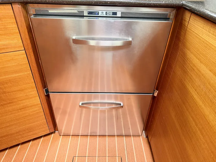 Starship Yacht Photos Pics Stainless steel dishwasher in 2017 Gunboat 55 yacht kitchen with wooden cabinetry.