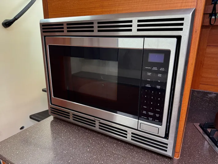 Starship Yacht Photos Pics Built-in microwave in 2017 Gunboat 55 yacht kitchen, featuring stainless steel finish and digital controls.