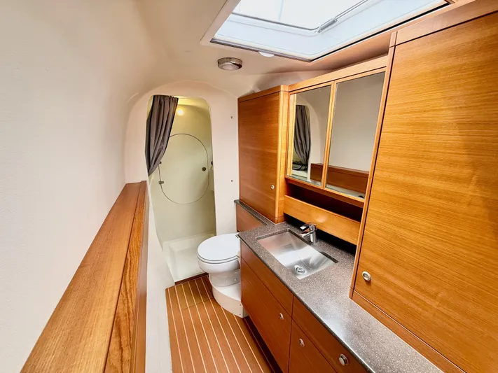 Starship Yacht Photos Pics Luxurious bathroom in 2017 Gunboat 55 yacht with wood cabinetry and modern fixtures.