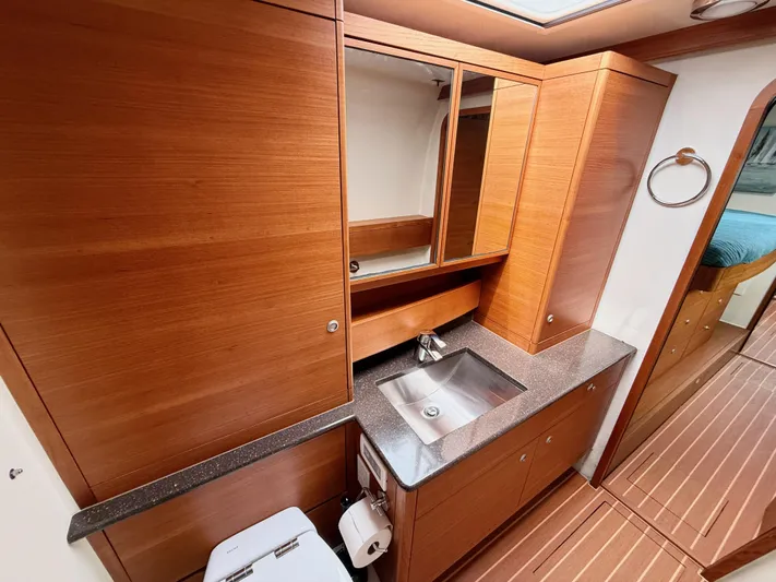 Starship Yacht Photos Pics Luxurious 2017 Gunboat 55 yacht bathroom with wooden cabinetry and modern fixtures.
