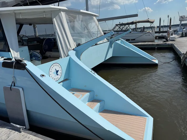 Starship Yacht Photos Pics 2017 Gunboat 55 catamaran docked at marina, featuring sleek blue design and spacious deck.