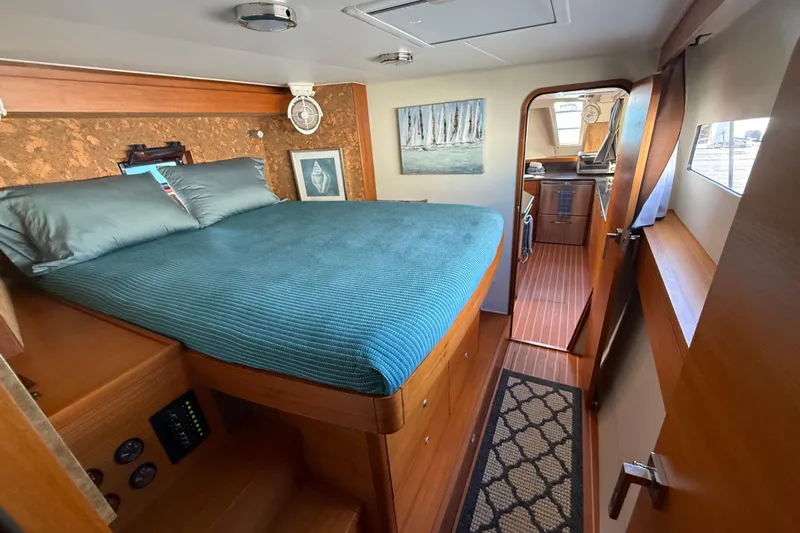 Starship Yacht Photos Pics Luxurious interior of 2017 Gunboat 55 yacht with cozy bedroom and elegant wood finishes.