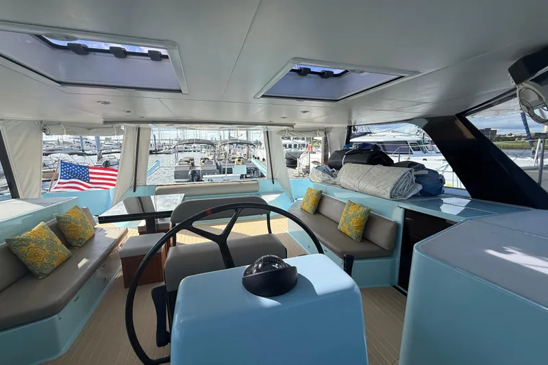 Starship Yacht Photos Pics Interior of 2017 Gunboat 55 yacht with seating, helm, and American flag.