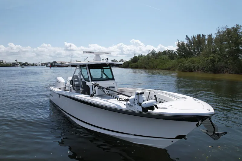  Yacht Photos Pics 2024 Blackfin 332 CC boat on calm water, featuring sleek design and advanced navigation equipment.