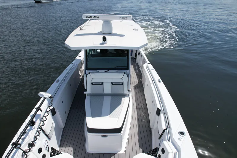  Yacht Photos Pics 2024 Blackfin 332 CC boat cruising on open water, featuring sleek design and advanced navigation equipment.