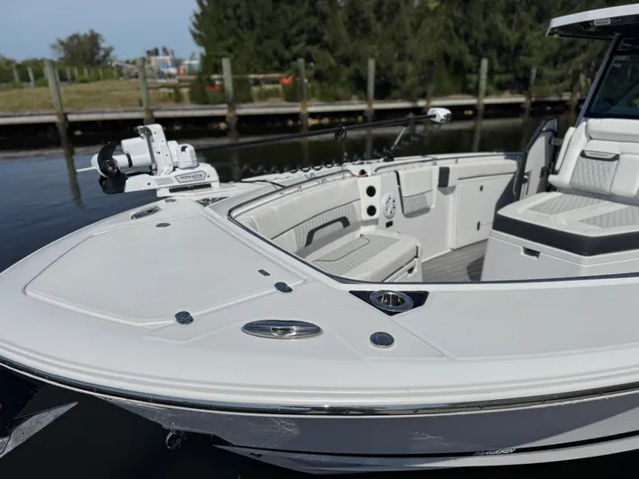  Yacht Photos Pics 2024 Blackfin 332 CC boat with spacious deck and seating, docked by the water.