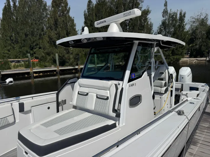  Yacht Photos Pics 2024 Blackfin 332 CC boat docked, featuring sleek design and advanced Garmin navigation system.