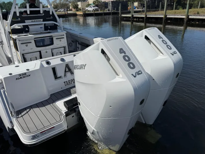  Yacht Photos Pics 2024 Blackfin 332 CC boat with dual Mercury 400 V10 engines docked by the water.
