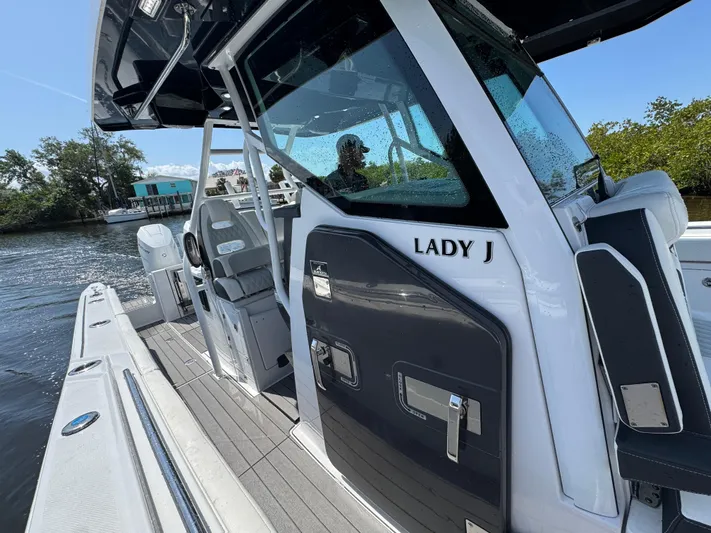  Yacht Photos Pics 2024 Blackfin 332 CC boat, sleek design, docked on a sunny day.