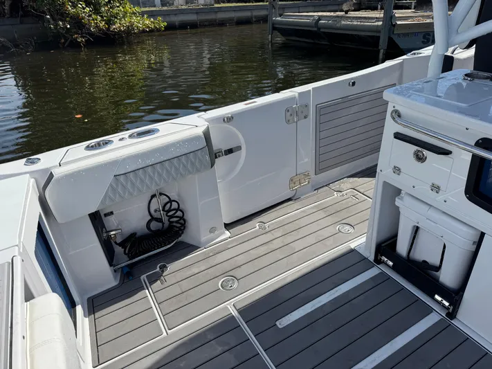  Yacht Photos Pics 2024 Blackfin 332 CC boat interior with sleek deck and storage compartments.