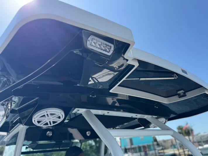  Yacht Photos Pics 2024 Blackfin 332 CC boat canopy with speakers and lighting, under clear blue sky.