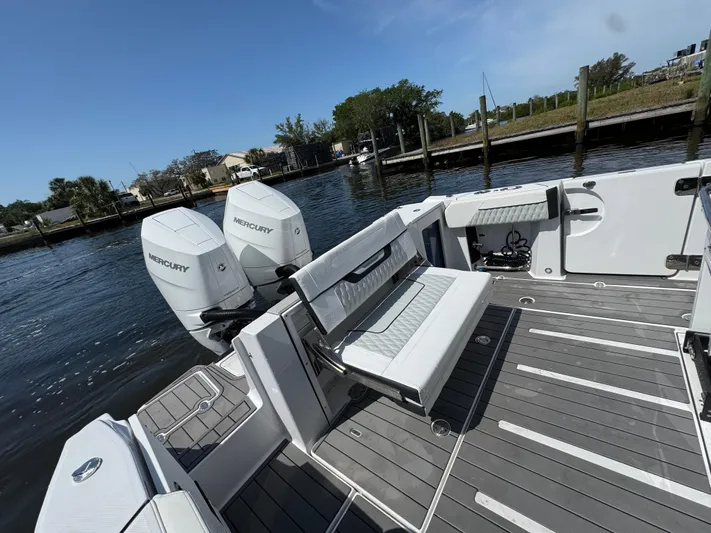  Yacht Photos Pics 2024 Blackfin 332 CC boat with Mercury engines, featuring spacious deck and seating.