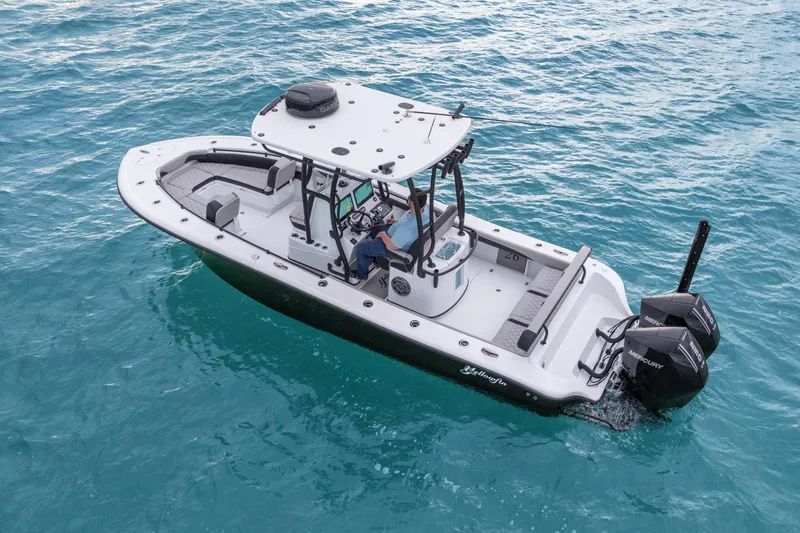  Yacht Photos Pics 2025 Yellowfin 26 Hybrid boat on clear blue water, featuring dual Mercury engines.