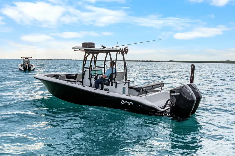  Yacht Photos Pics 2025 Yellowfin 26 Hybrid boat on open water under a clear blue sky.