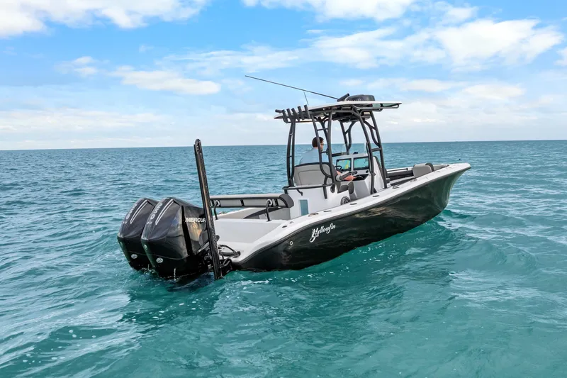  Yacht Photos Pics 2025 Yellowfin 26 Hybrid boat cruising on open ocean under clear blue sky.