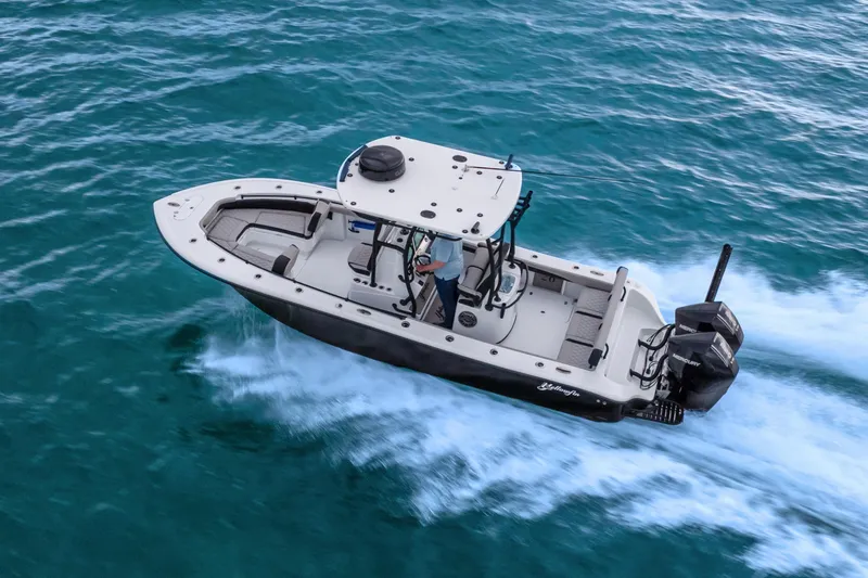  Yacht Photos Pics 2025 Yellowfin 26 Hybrid boat cruising on open water.