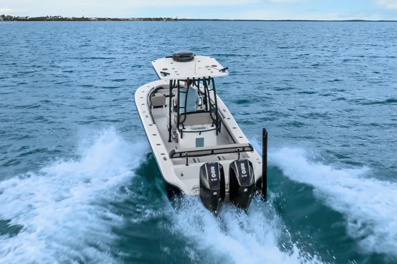  Yacht Photos Pics 2025 Yellowfin 26 Hybrid boat cruising on open water with twin engines.