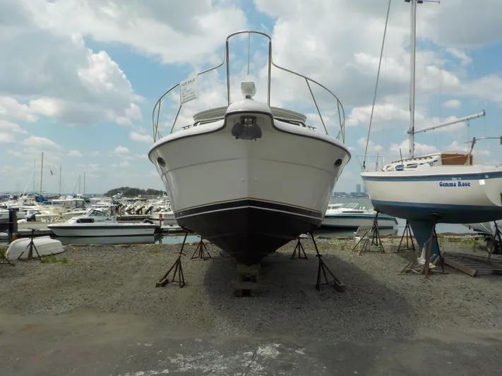 " Sea Goll " Yacht Photos Pics 2003 Tiara Yachts 3100 Open on dry dock, marina background, partly cloudy sky.