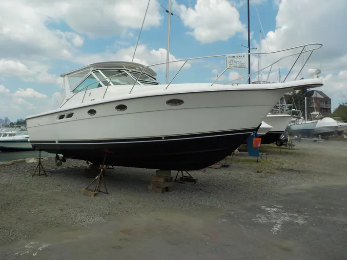" Sea Goll " Yacht Photos Pics 2003 Tiara Yachts 3100 Open boat on stands, displayed for sale under a cloudy sky.