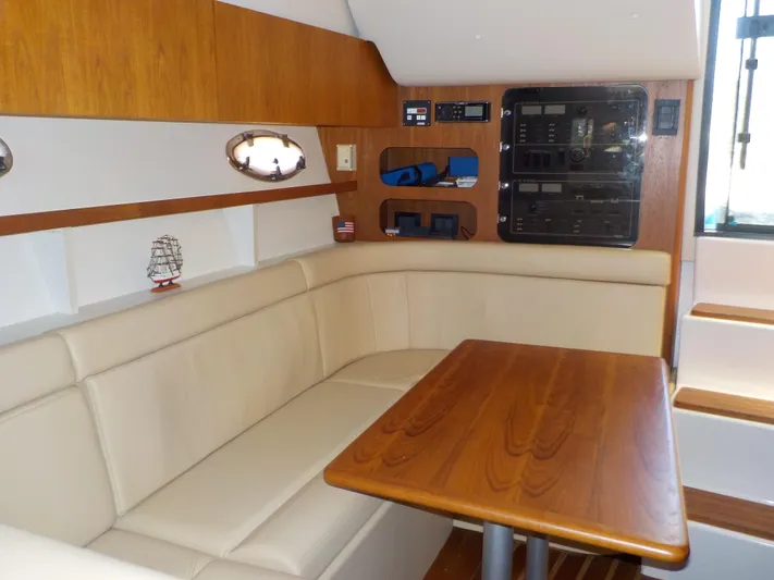 " Sea Goll " Yacht Photos Pics 2003 Tiara Yachts 3100 Open interior with beige seating and wooden table.