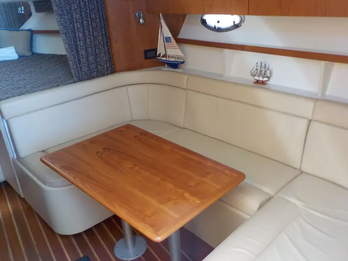 " Sea Goll " Yacht Photos Pics Interior of 2003 Tiara Yachts 3100 Open with cozy seating and wooden table.