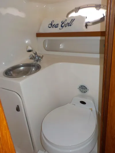 " Sea Goll " Yacht Photos Pics Compact bathroom in 2003 Tiara Yachts 3100 Open, featuring sink and toilet.