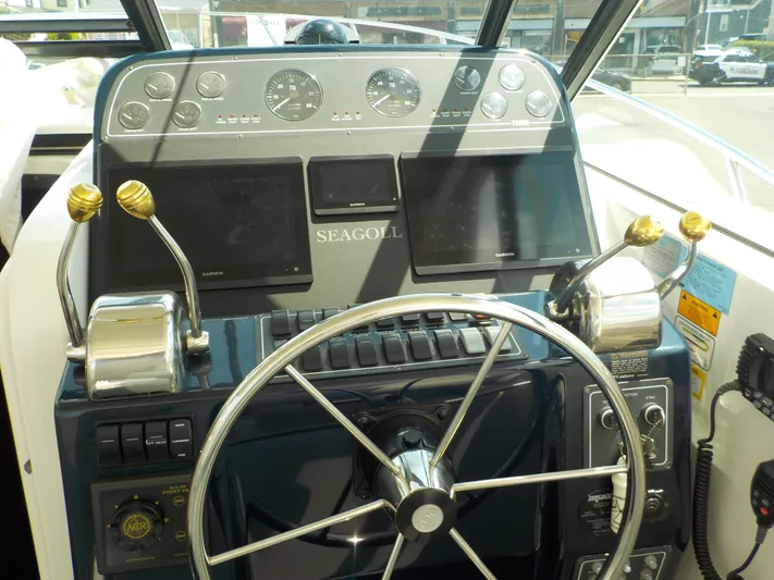 " Sea Goll " Yacht Photos Pics 2003 Tiara Yachts 3100 Open helm with steering wheel, controls, and Garmin displays.