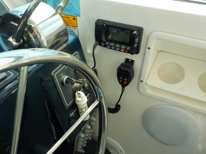 " Sea Goll " Yacht Photos Pics Helm of 2003 Tiara Yachts 3100 Open with steering wheel and communication equipment.