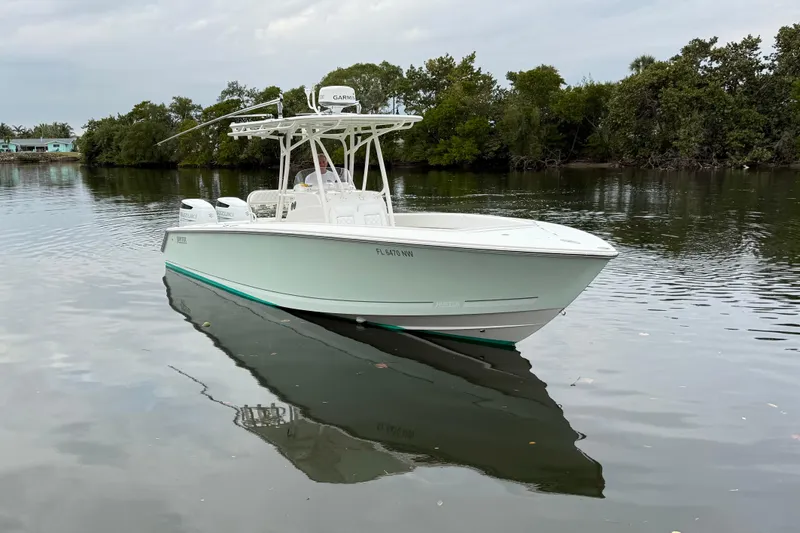  Yacht Photos Pics 2009 Jupiter 29 boat on calm water, surrounded by lush greenery.
