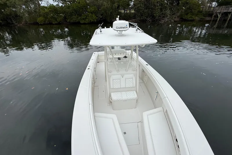  Yacht Photos Pics 2009 Jupiter 29 boat with Garmin equipment on calm water, surrounded by trees.
