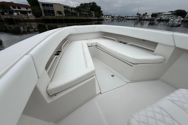  Yacht Photos Pics 2009 Jupiter 29 boat interior with white cushioned seating and storage compartments.
